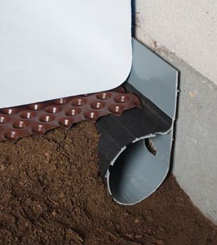 Closeup of a crawl space drainage system installed in Newmarket