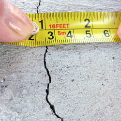 A crack in a poured concrete wall that's showing a normal crack during curing in Milford